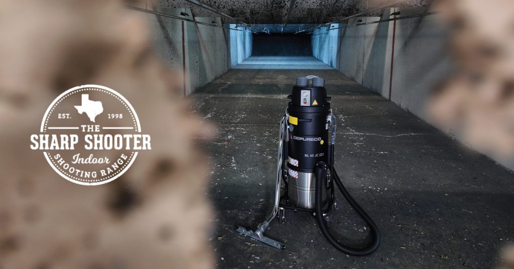 The Sharp Shooter logo in front of a blurry paper target; through the bullet holes you can see a Depureco BL 45 JC Z22 vacuum sitting mid-lane inside an indoor shooting range, downrange visible in the background.
